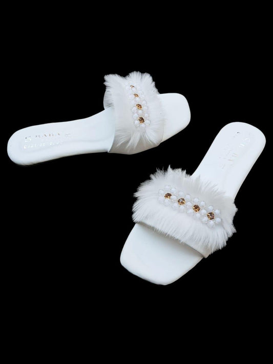 Step into luxury and comfort with our exquisite White Fur Flats – where elegance meets everyday comfort.